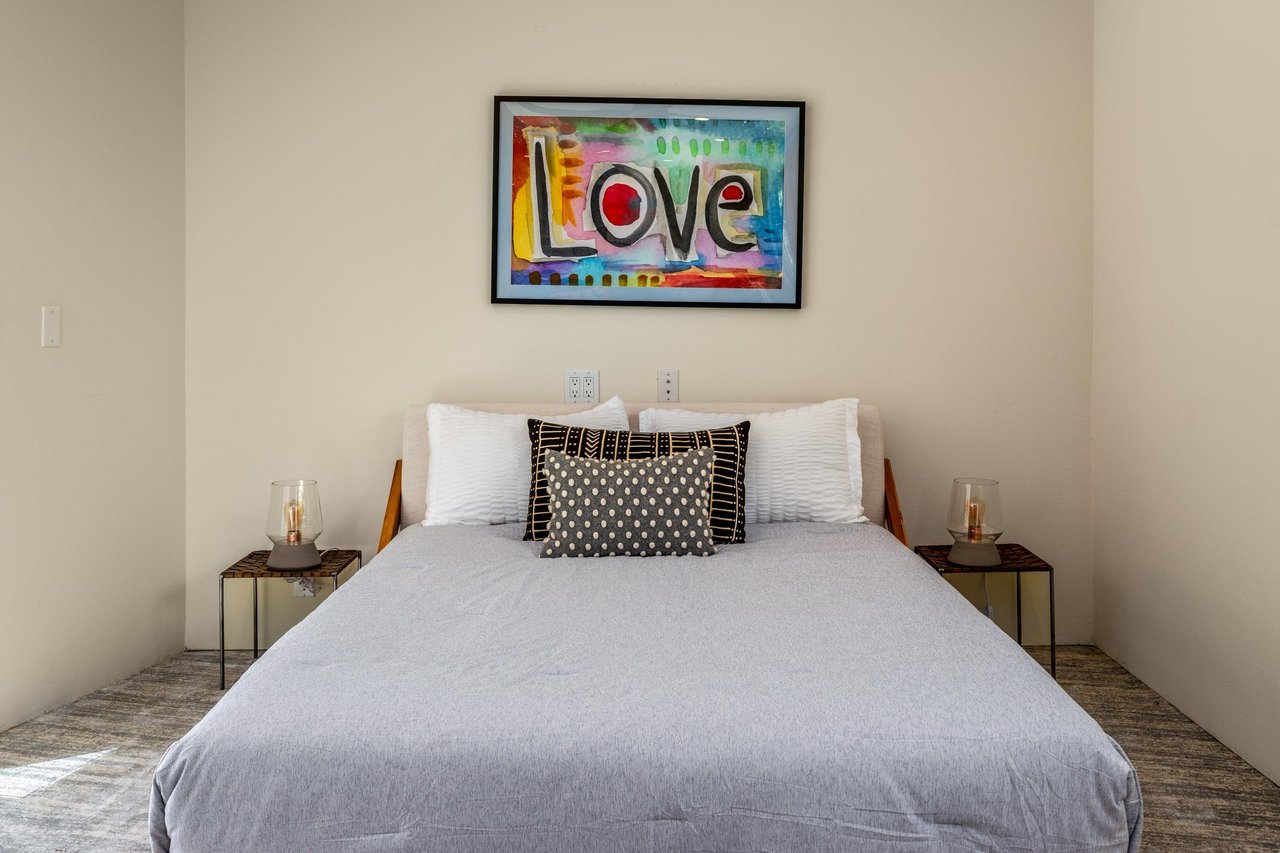 Features a queen size bed, own sitting area, smart TV, patio access, and ensuite bathroom.