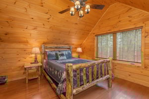 Log bed, two night stands, and two lamps at Js Hideaway, a 4 bedroom cabin rental located in Pigeon Forge