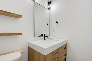 Refresh in your sleek private bathroom with modern marble countertop and warm wood accents, combining style and comfort for your stay.