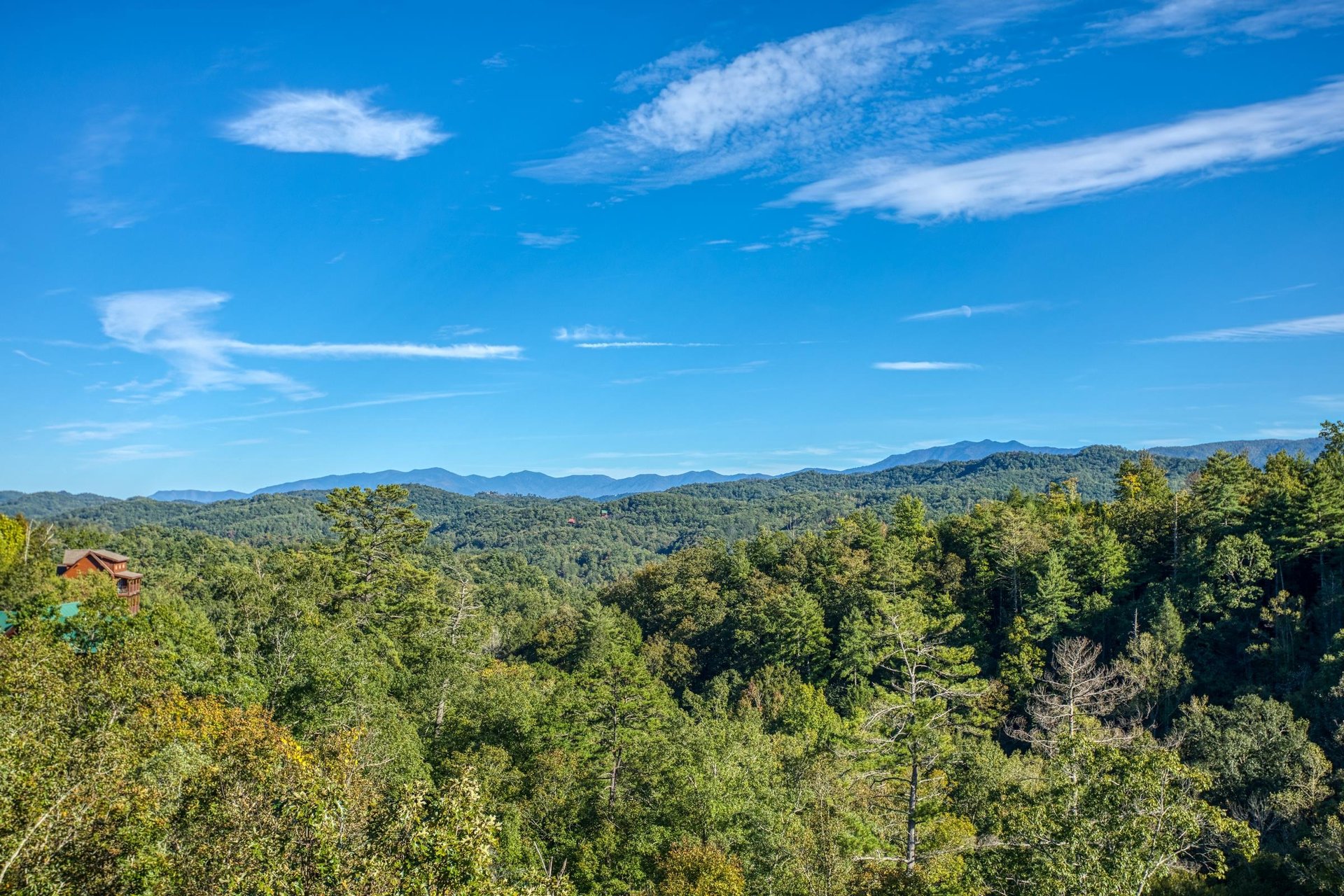 Treetops and mountains viewed from the deck at Great View Lodge, a 5bedroom cabin rental located in Pigeon Forge