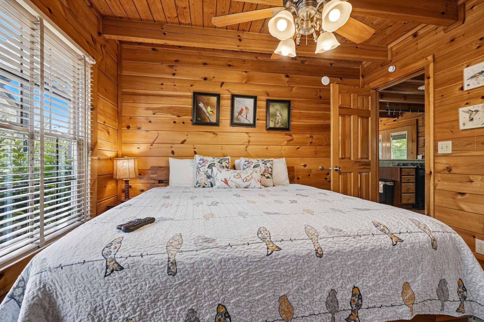 Drift off in your cozy log cabin bedroom, where warm wood walls and charming wildlifethemed bedding create the perfect rustic retreat.