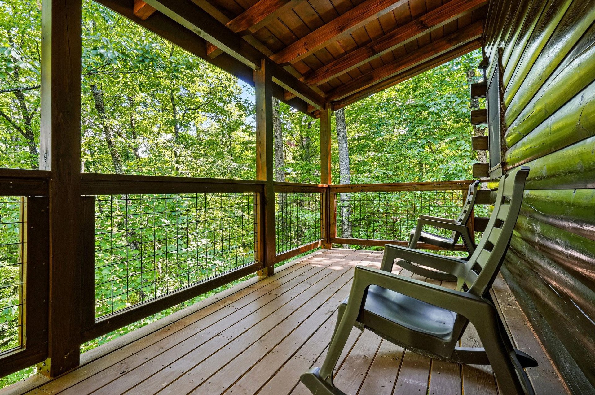 Imagine yourself unwinding on your private covered deck, surrounded by towering trees and the peaceful sounds of nature. Perfectly shaded seating invites you to sip morning coffee or relax with a book