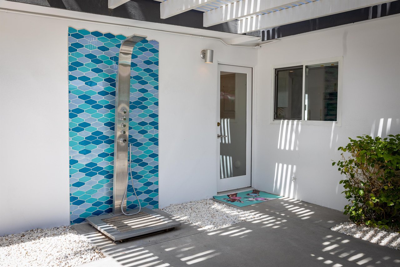 Outdoor Shower With Blue Tile Backsplash