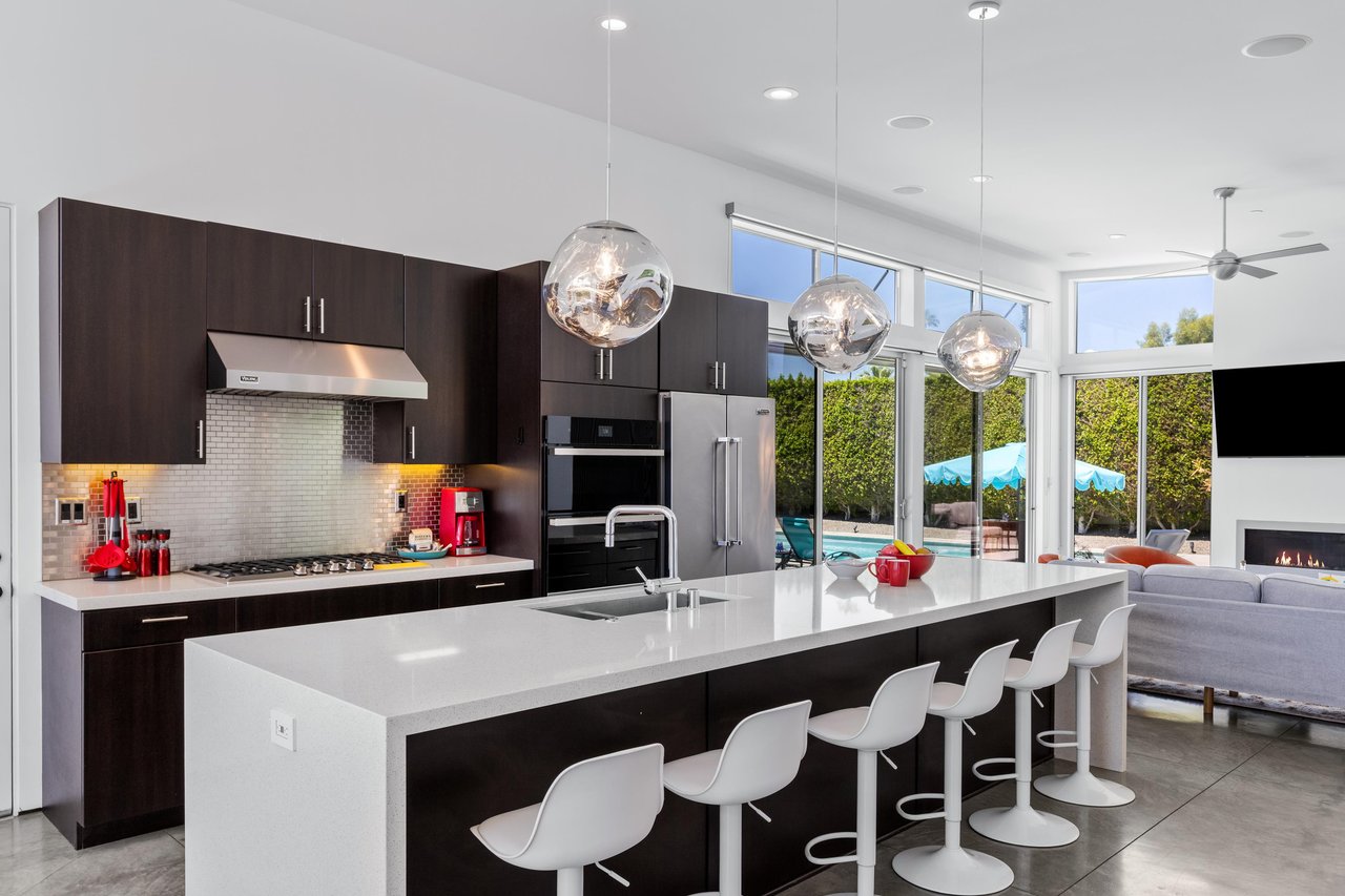 Stainless steel appliances, counter seating for 6 guests, cooking essentials, and large island.