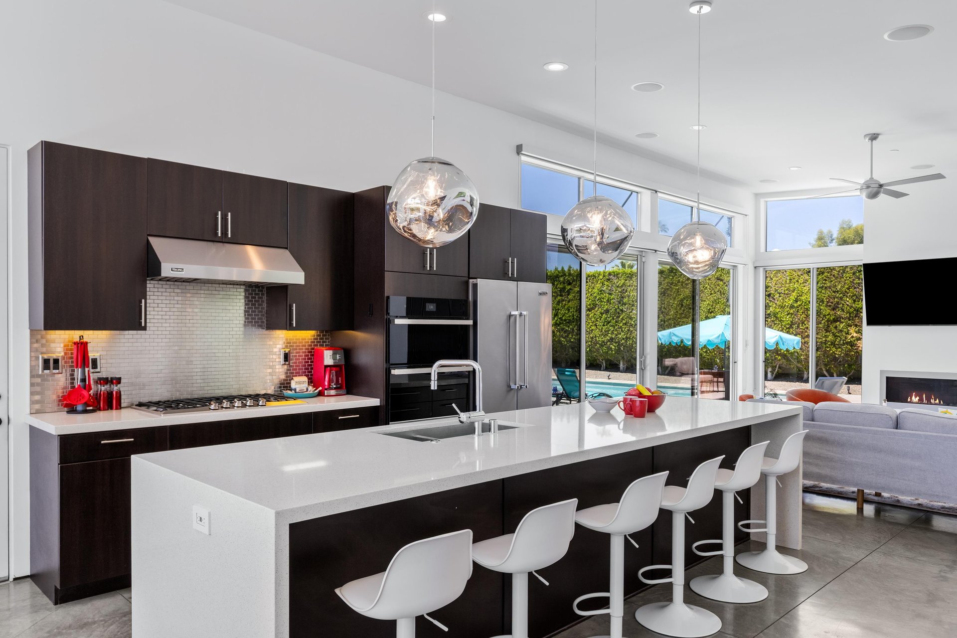 Stainless steel appliances, counter seating for 6 guests, cooking essentials, and large island.