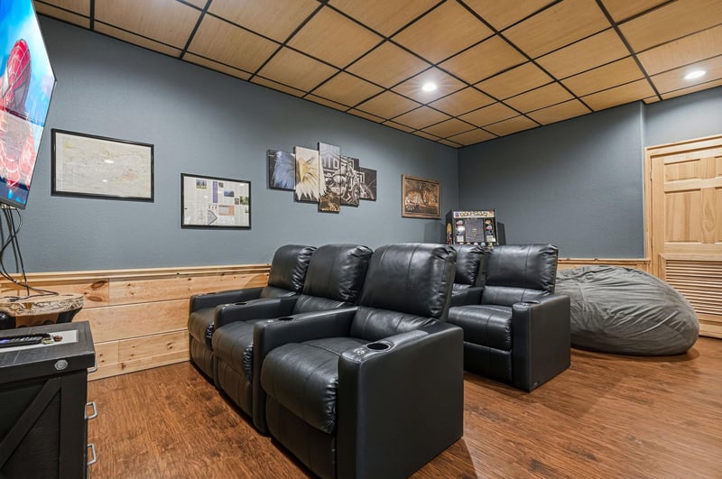 Sink into plush leather recliners for your ultimate movie night experience in this cozy entertainment room designed for pure relaxation.