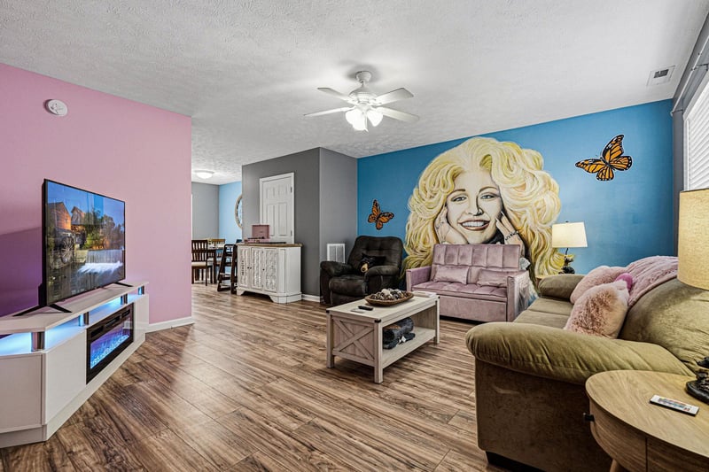 Your vibrant living space features colorful walls, comfy seating, and a stunning butterfly mural that brings joy to your stay.