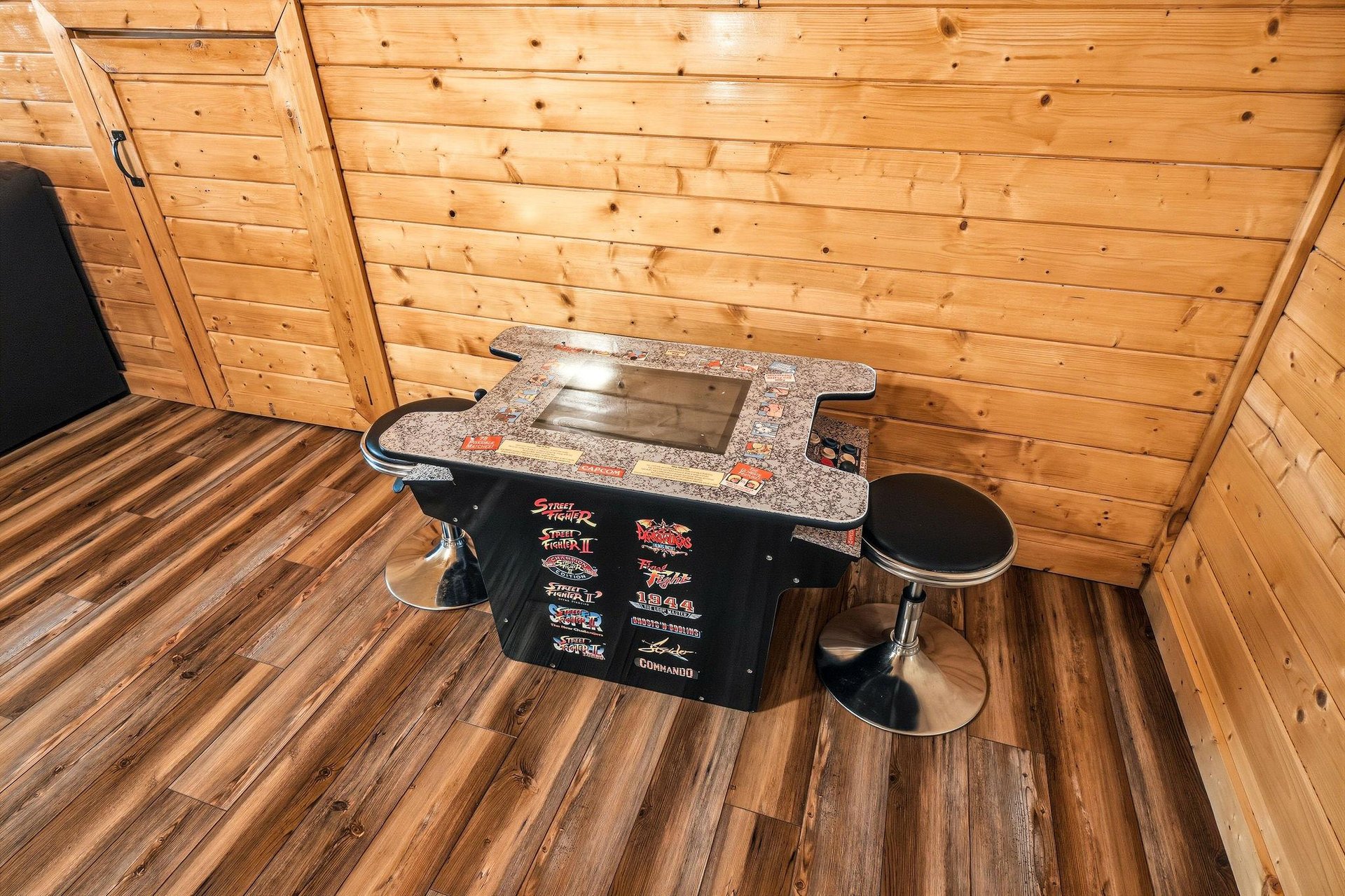 Challenge your friends to a friendly competition on this classic arcadestyle cocktail table—your goto spot for memorable game nights in this cozy cabin retreat.