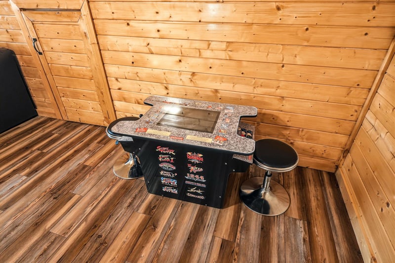 Challenge your friends to a friendly competition on this classic arcadestyle cocktail table—your goto spot for memorable game nights in this cozy cabin retreat.