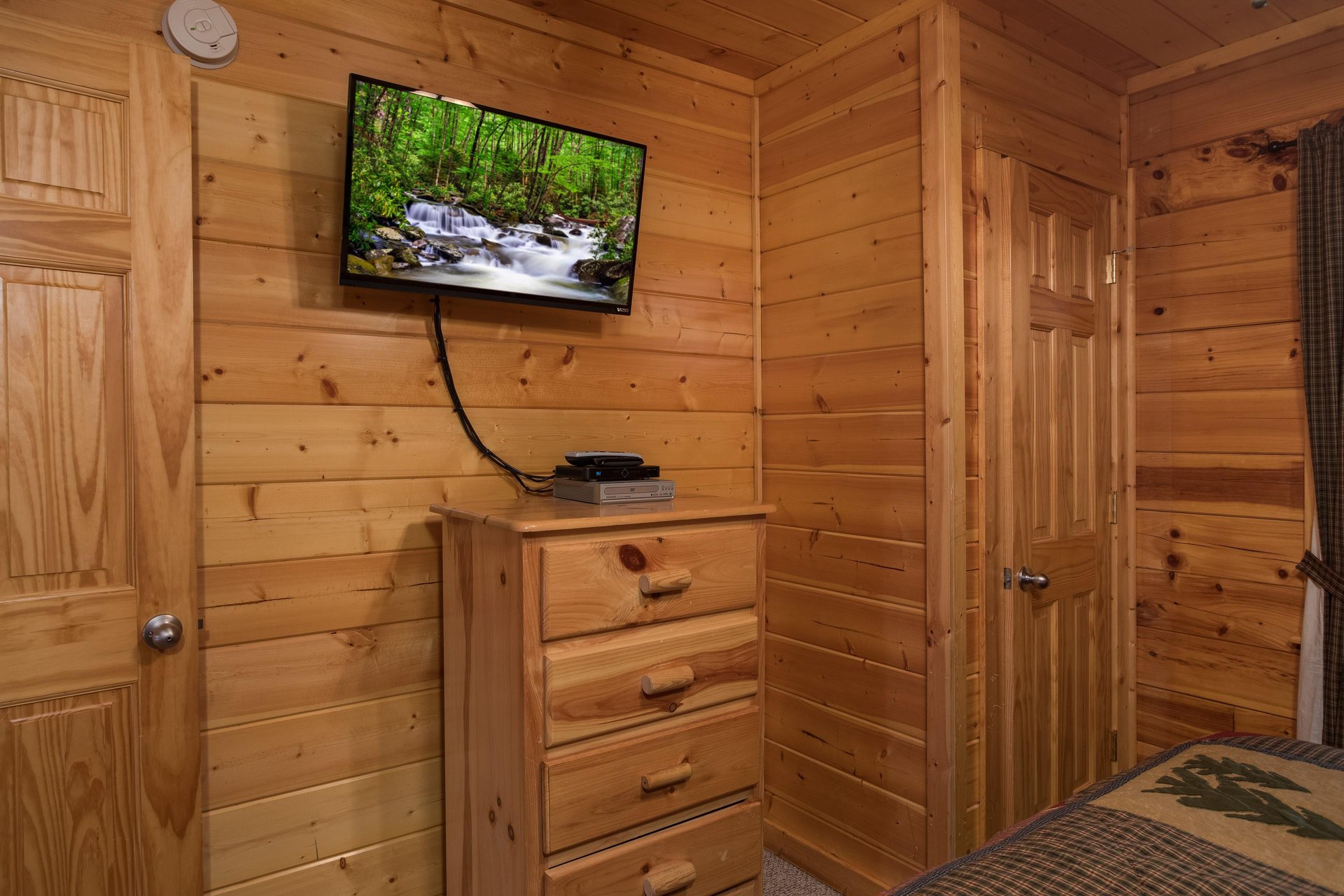 Dresser and TV in a bedroom at Kick Back  Relax A 4 bedroom cabin rental located in Pigeon Forge
