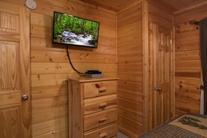 Dresser and TV in a bedroom at Kick Back  Relax A 4 bedroom cabin rental located in Pigeon Forge