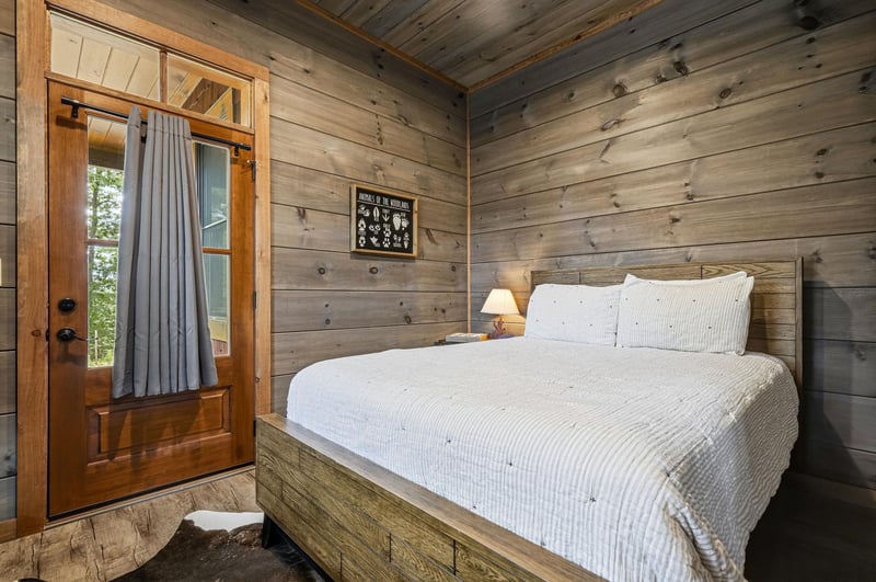 Step into your cozy rustic retreat—weathered wood, soft natural light, and a plush bed await. Fall asleep to the whisper of trees right outside.