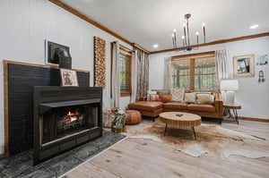 Cozy up by your crackling fireplace in this warmly appointed living room, where leather seating and rustic wood touches create your perfect mountain retreat.