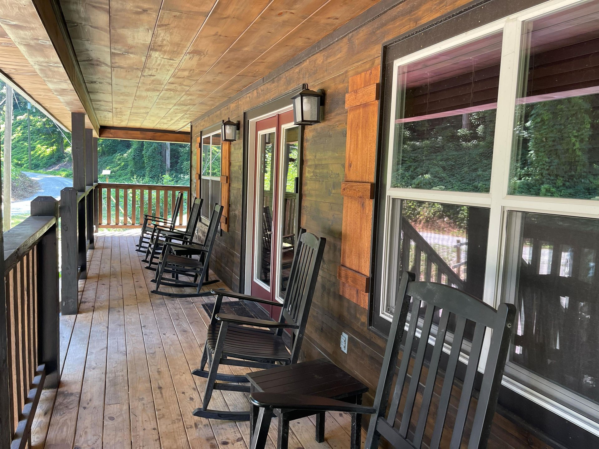 Your private covered porch invites you to slow down and unwind, where rocking chairs face a peaceful, leafy neighborhood—perfect for morning coffee or evening conversation.