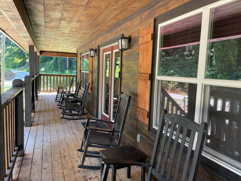 Your private covered porch invites you to slow down and unwind, where rocking chairs face a peaceful, leafy neighborhood—perfect for morning coffee or evening conversation.