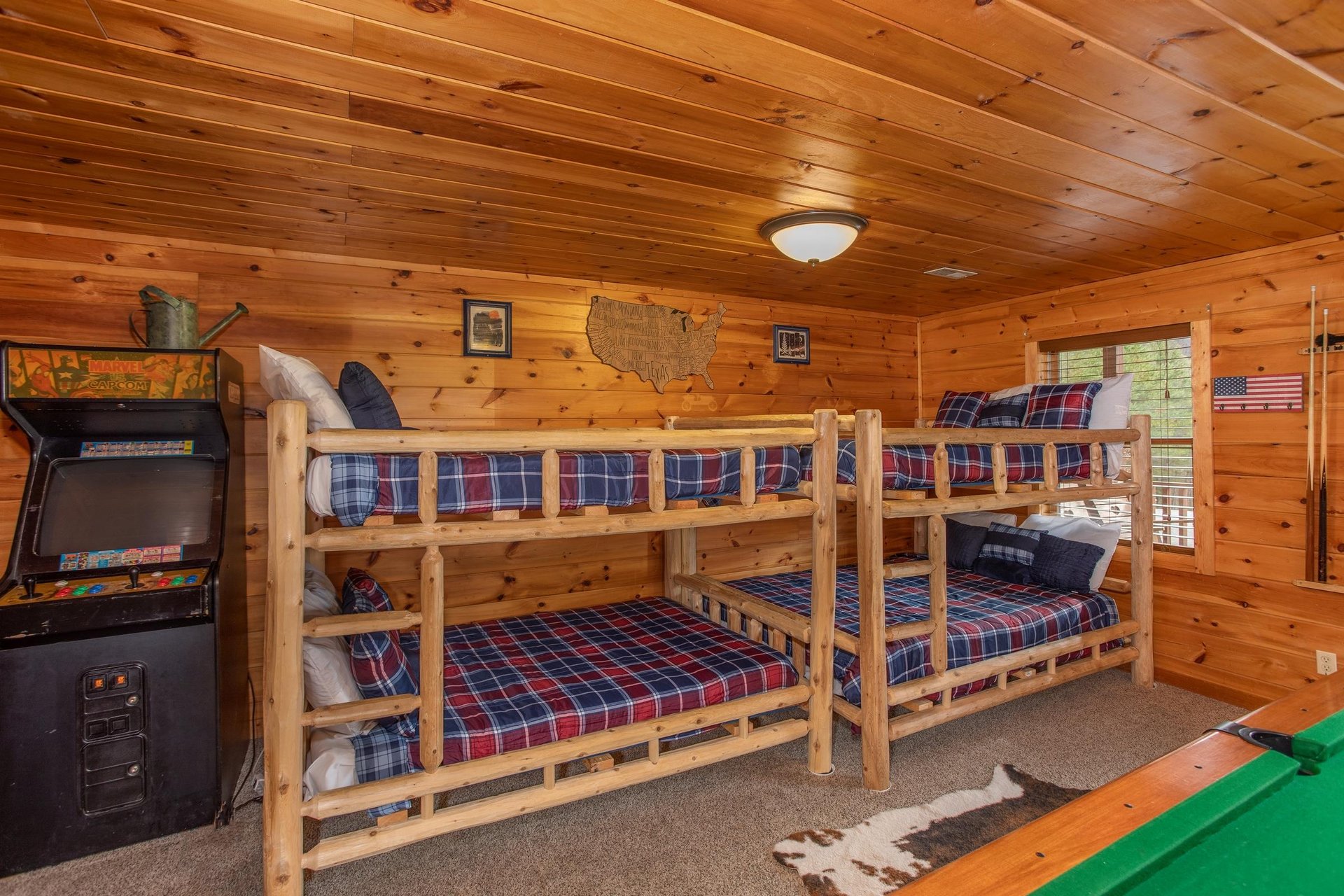 Two sets of fullsized bunk beds in the game room at Hibernation Station, a 3bedroom cabin rental located in Pigeon Forge