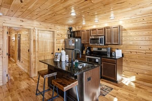 Your fullyequipped kitchen features granite countertops and rustic wooden warmth, perfect for preparing memorable meals together.