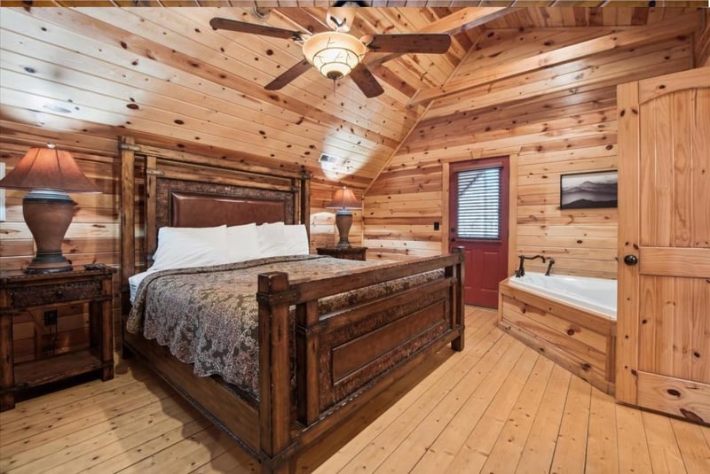 Retreat to your rustic log bedroom, where warm wood surrounds you and a cozy jetted tub awaits your evening relaxation.