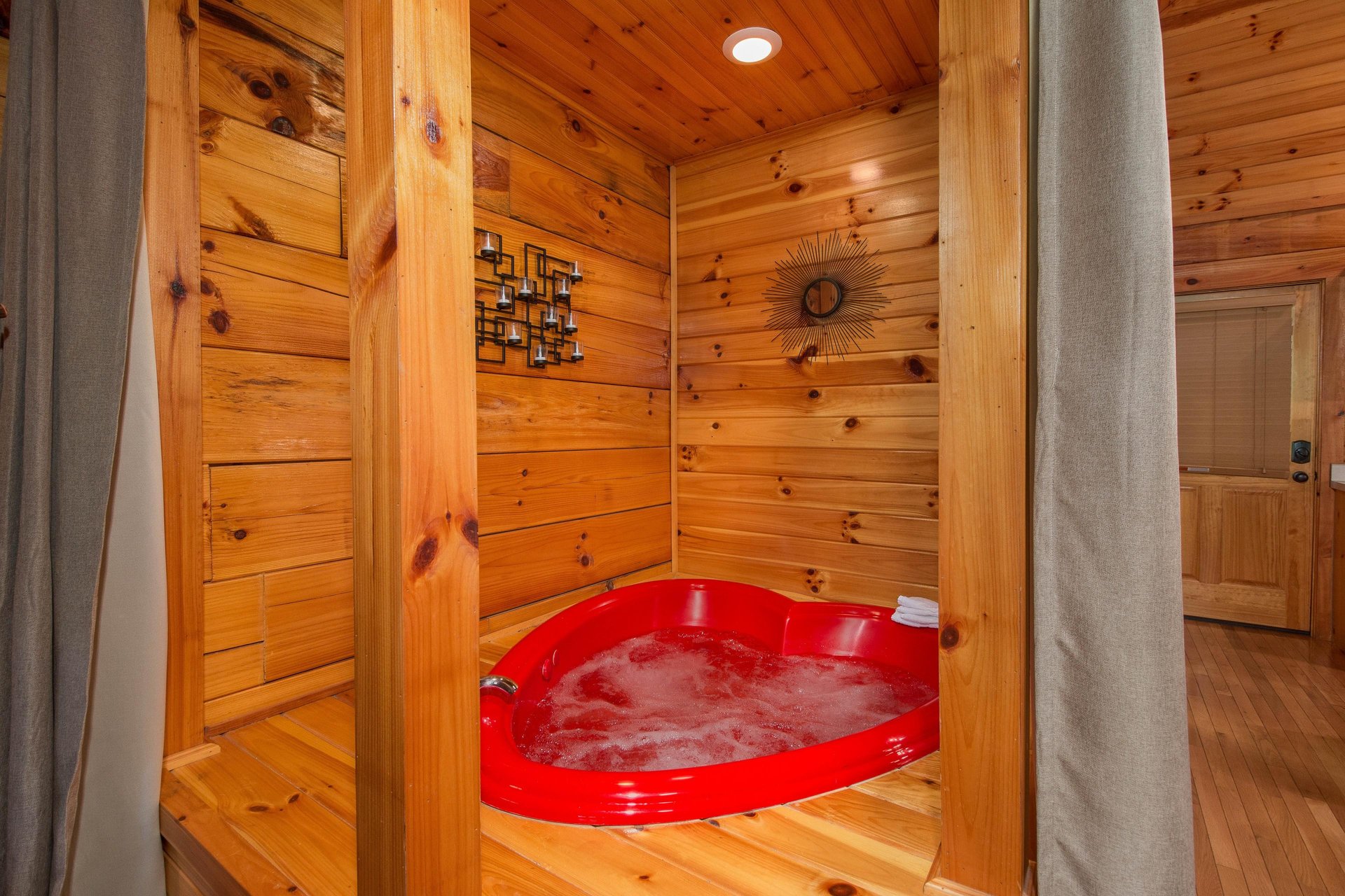 A heart shaped jacuzzi tub at Kellys Cabin, a 1 bedroom cabin rental located in Pigeon Forge