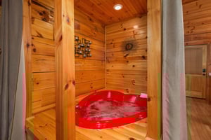 A heart shaped jacuzzi tub at Kellys Cabin, a 1 bedroom cabin rental located in Pigeon Forge