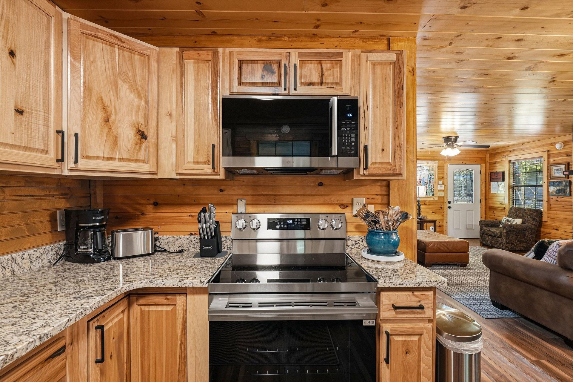 Your cabin getaway features a fullyequipped kitchen with stainless steel appliances, granite counters, and warm wood cabinetry. Cook your favorite meals while enjoying the cozy, open layout that flow