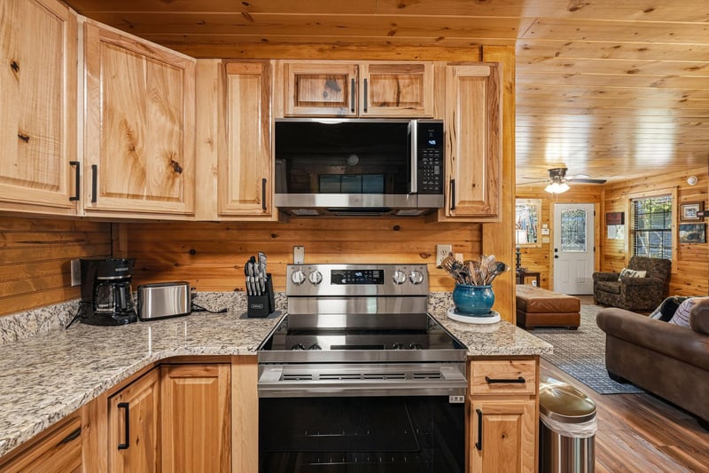 Your cabin getaway features a fullyequipped kitchen with stainless steel appliances, granite counters, and warm wood cabinetry. Cook your favorite meals while enjoying the cozy, open layout that flow