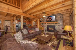 Living room with sofa bed and stone fireplace