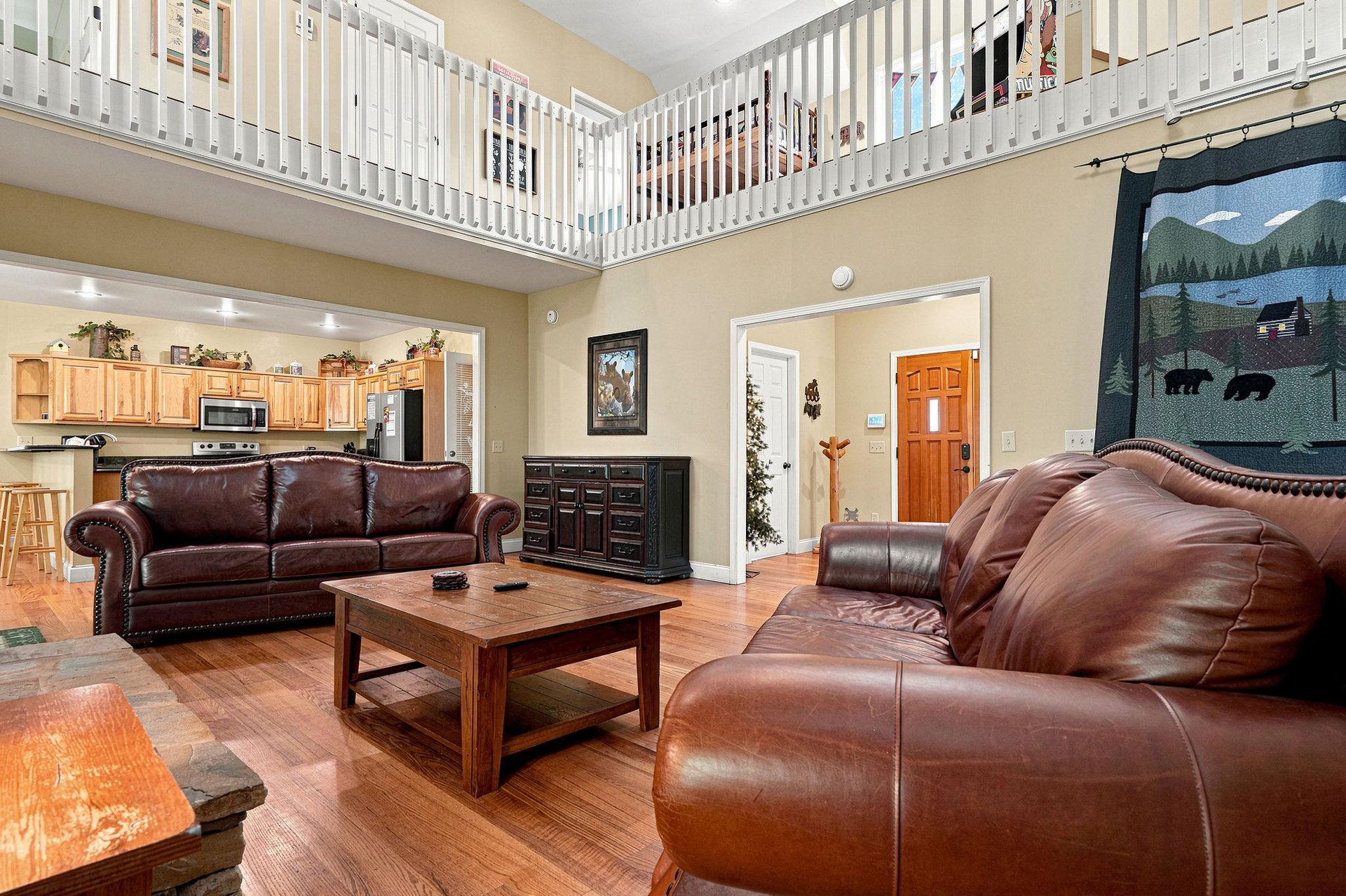 Relax in your spacious living room with vaulted ceilings and a loft. Plush leather sofas, rustic charm, and an open layout create a welcoming retreat for unwinding after your adventures.