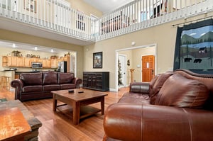 Relax in your spacious living room with vaulted ceilings and a loft. Plush leather sofas, rustic charm, and an open layout create a welcoming retreat for unwinding after your adventures.