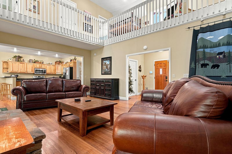 Relax in your spacious living room with vaulted ceilings and a loft. Plush leather sofas, rustic charm, and an open layout create a welcoming retreat for unwinding after your adventures.