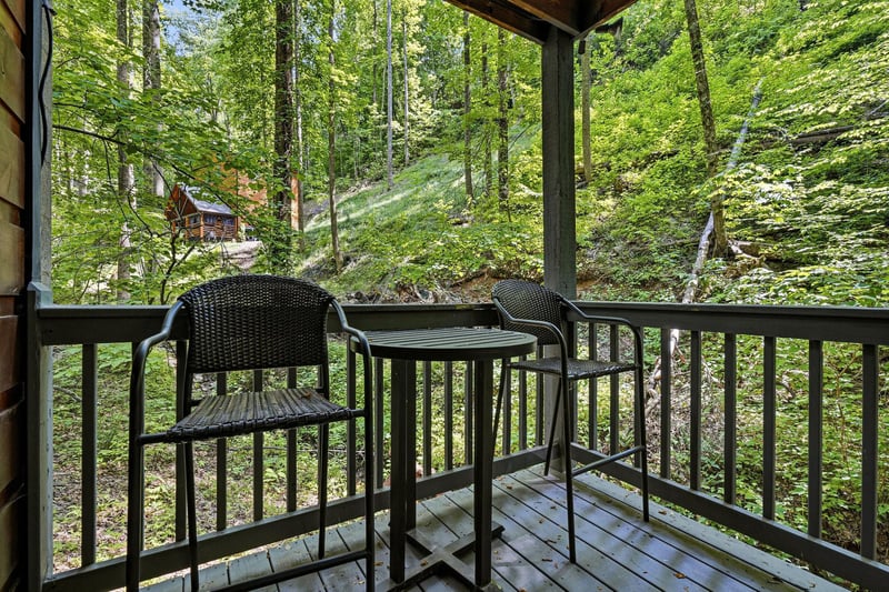 Sip morning coffee as birdsong fills the air and sunlight filters through towering trees. This cozy balcony offers your peaceful retreat into natures embrace.
