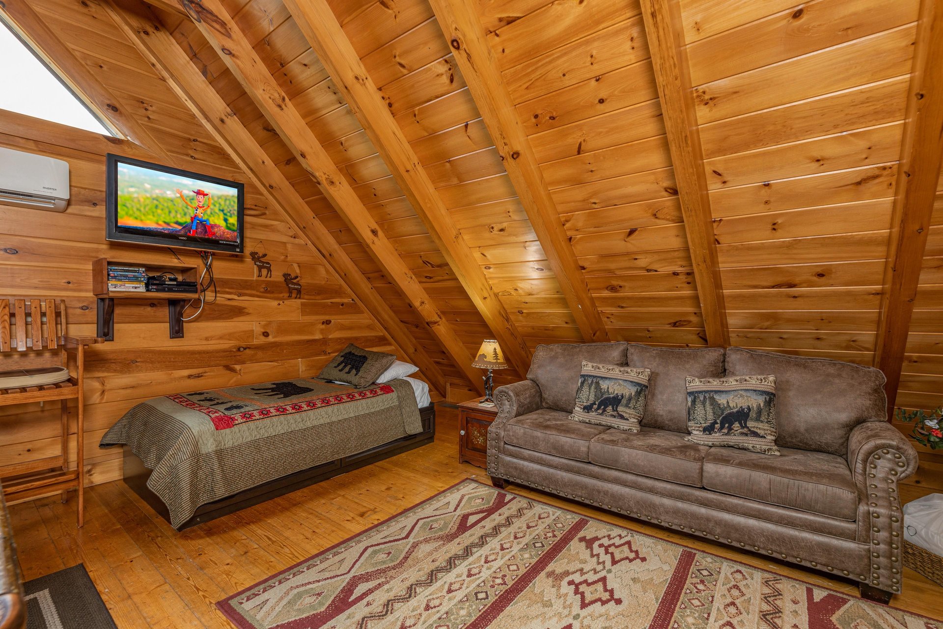Twin bed and sleeper sofa in the loft at Absolutely Wonderful, a 2 bedroom cabin rental located in Pigeon Forge