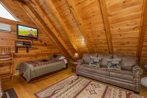 Twin bed and sleeper sofa in the loft at Absolutely Wonderful, a 2 bedroom cabin rental located in Pigeon Forge
