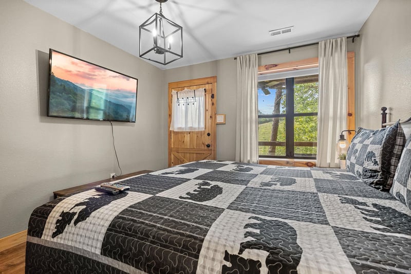 King bed with window and door to deck