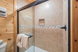 Walk in shower with stone walls