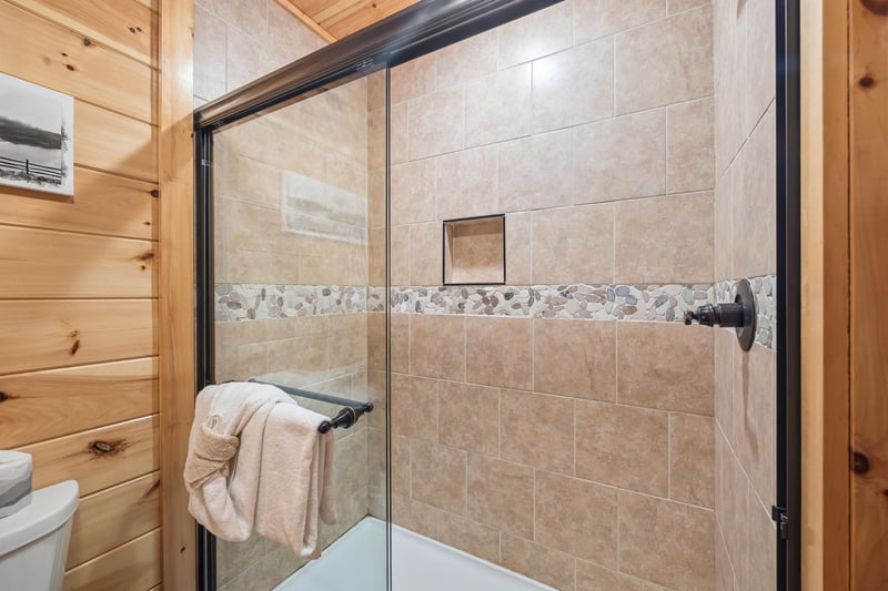 Walk in shower with stone walls