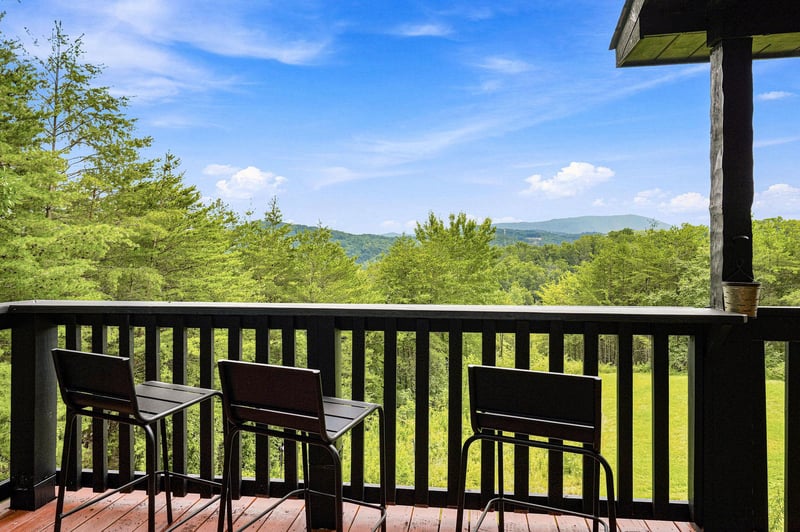 Your private balcony overlooks rolling green hills and forested mountains stretching to the horizon—perfect for morning coffee or evening relaxation in the fresh mountain air.