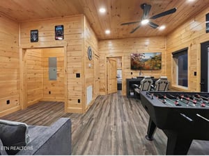 Your private game room features foosball, cozy seating, and rustic wood finishes perfect for family fun.