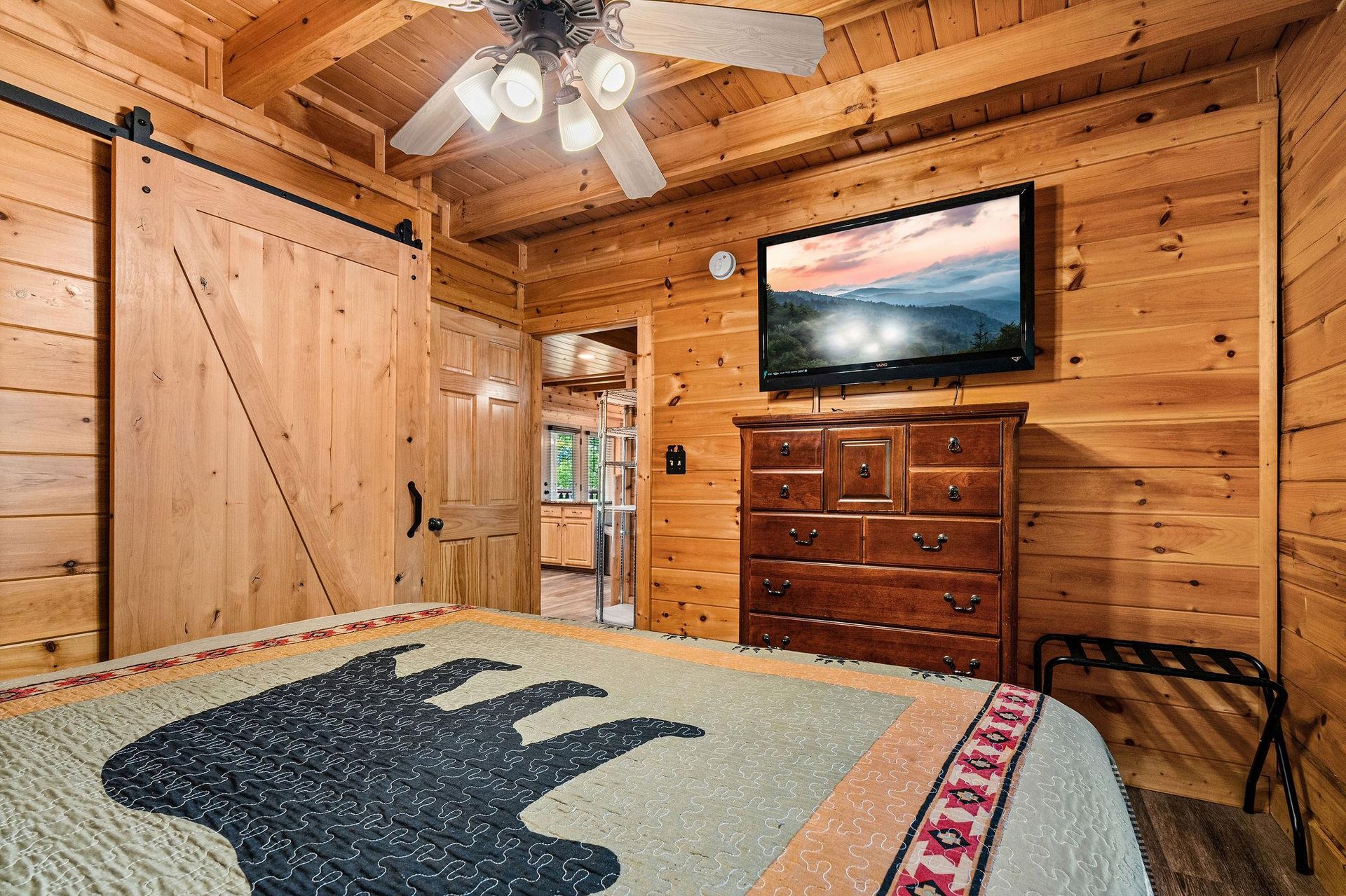 king bedroom with dresser and TV