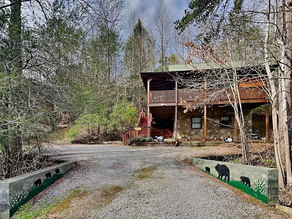 Rustic mountain retreat nestled among towering trees with spacious balconies and woodland serenity all around.
