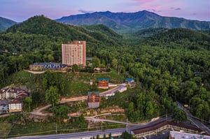 Nestled in the lush, forested hills of the Great Smoky Mountains, the property offers a serene mountain retreat beneath stunning twilight skies and dramatic ridgeline views.