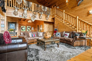 Rustic elegance meets mountain lodge charm in this inviting great room. Rich leather seating and soaring timber ceilings create the perfect retreat after your adventures.