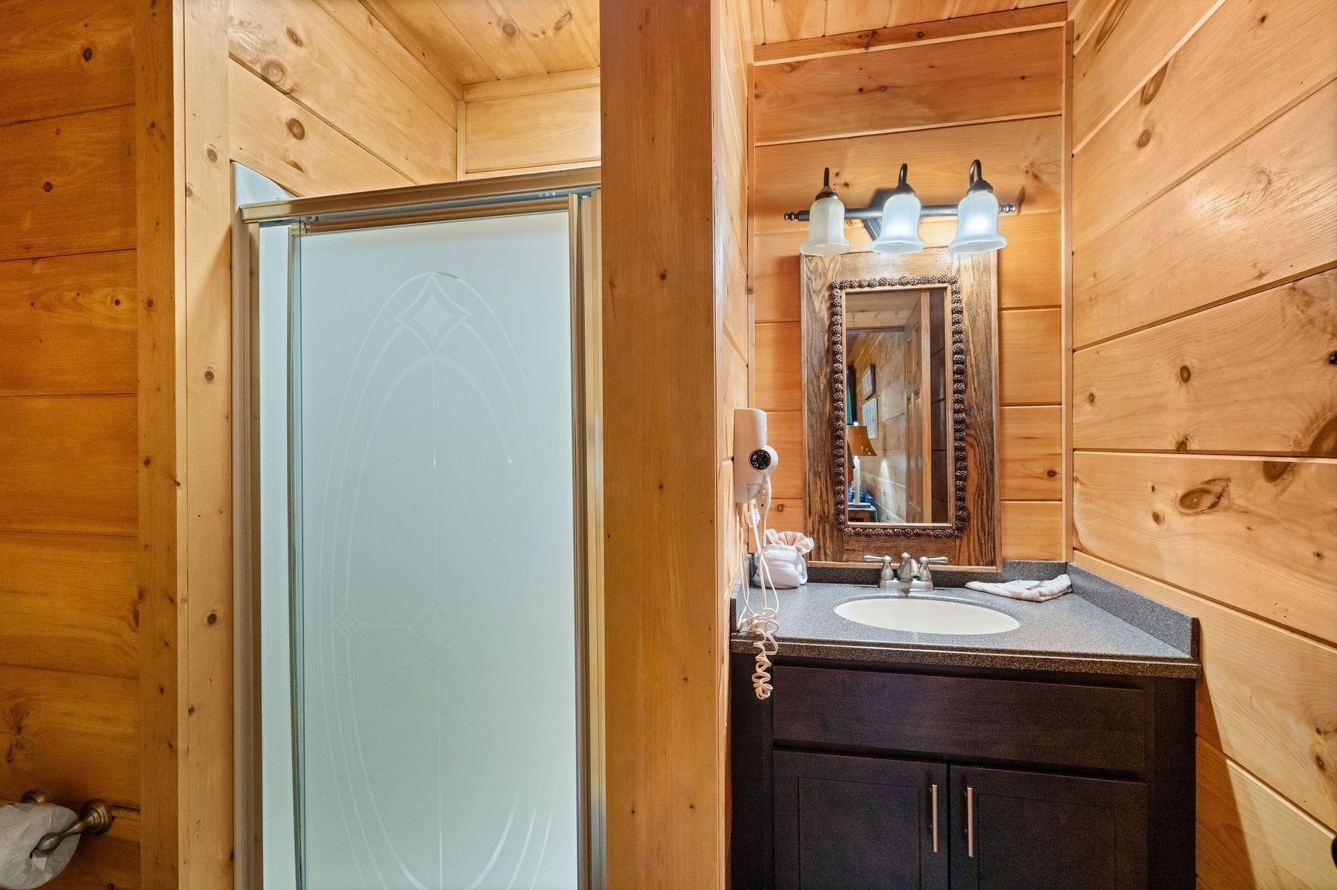 Step in shower with divider wall to single vanity sink