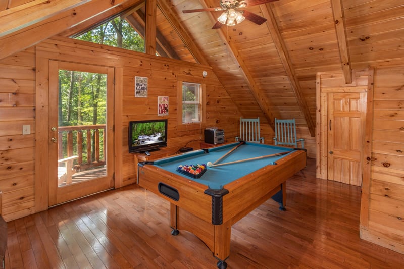 Green felted pool table in the game loft at Dreams Do Come True, a 1bedroom cabin rental located in Pigeon Forge