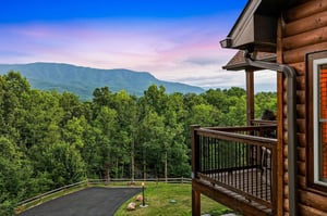 Stunning mountain views frame this secluded cabin nestled in lush forest, offering a peaceful retreat with sweeping natural scenery at every turn.