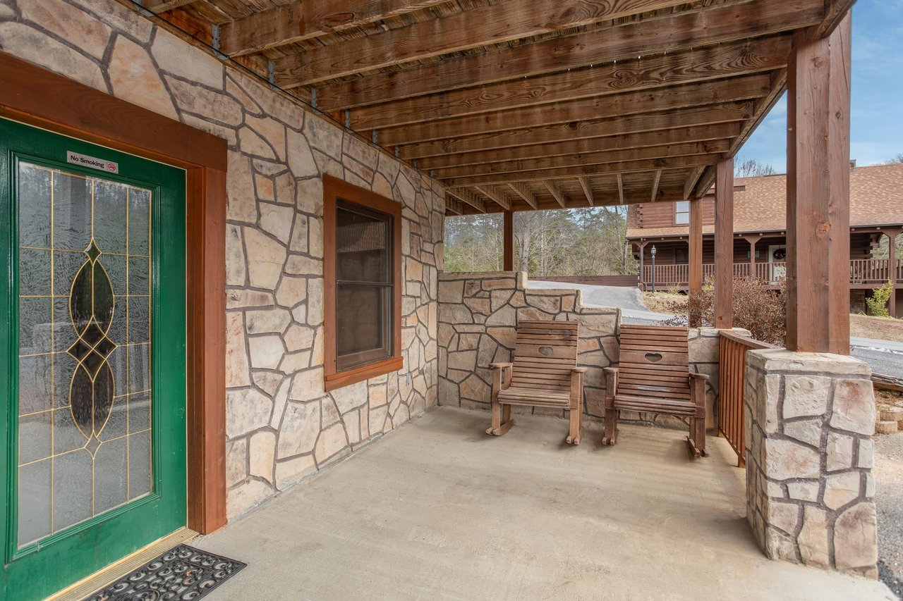 Front porch with two rocking chairs at Hibernation Station, a 3bedroom cabin rental located in Pigeon Forge