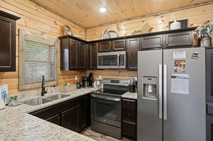Your fully equipped cabin kitchen blends rustic wood warmth with modern convenience for memorable meals together.