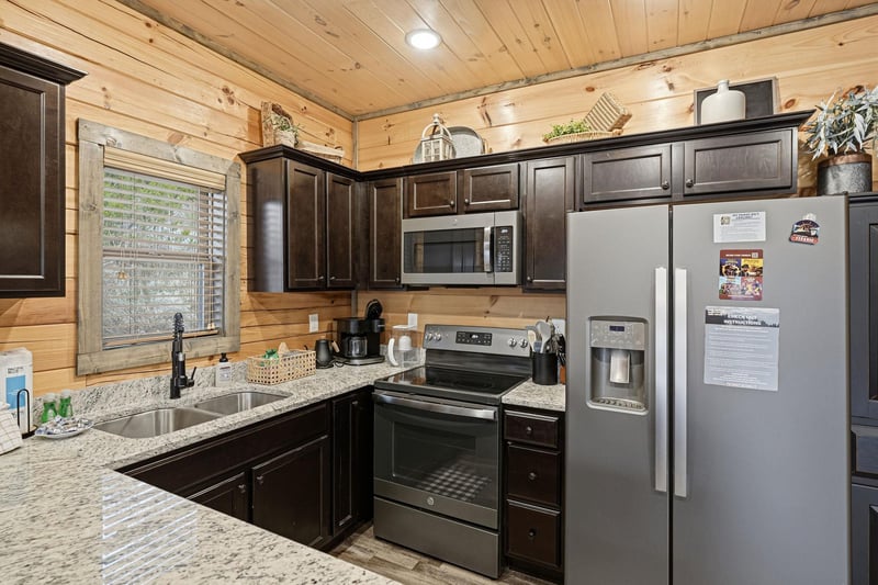 Your fully equipped cabin kitchen blends rustic wood warmth with modern convenience for memorable meals together.