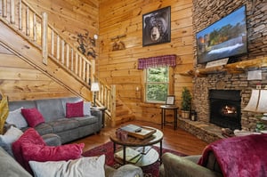 Sink into plush seating by the stone fireplace, where rustic charm meets modern comfort. Warm wood surrounds you as natural light fills the space, perfect for relaxing after your adventures.