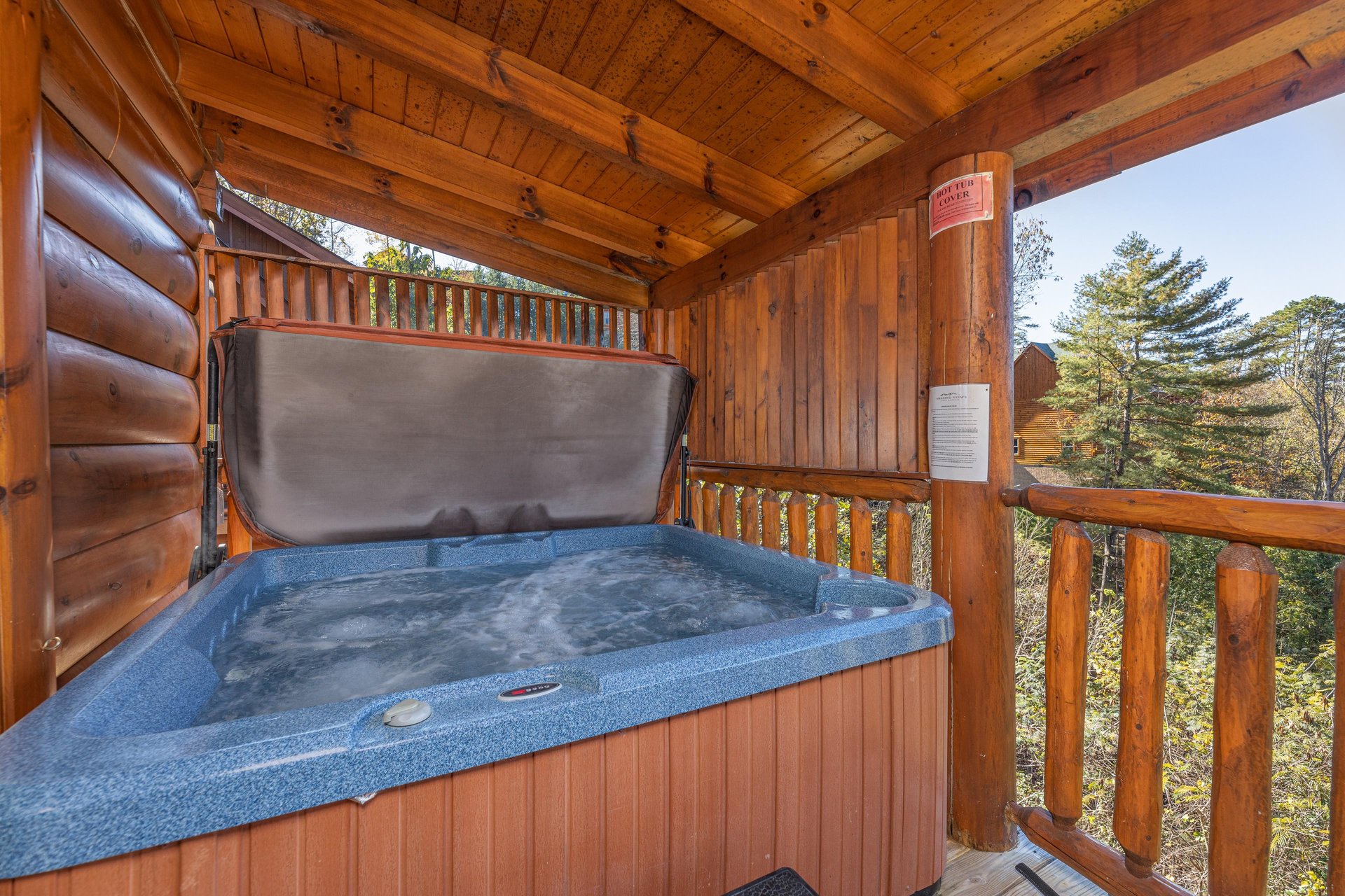Hot tub on a covered deck at Bears Dont Bluff, a 3 bedroom cabin rental located in Pigeon Forge